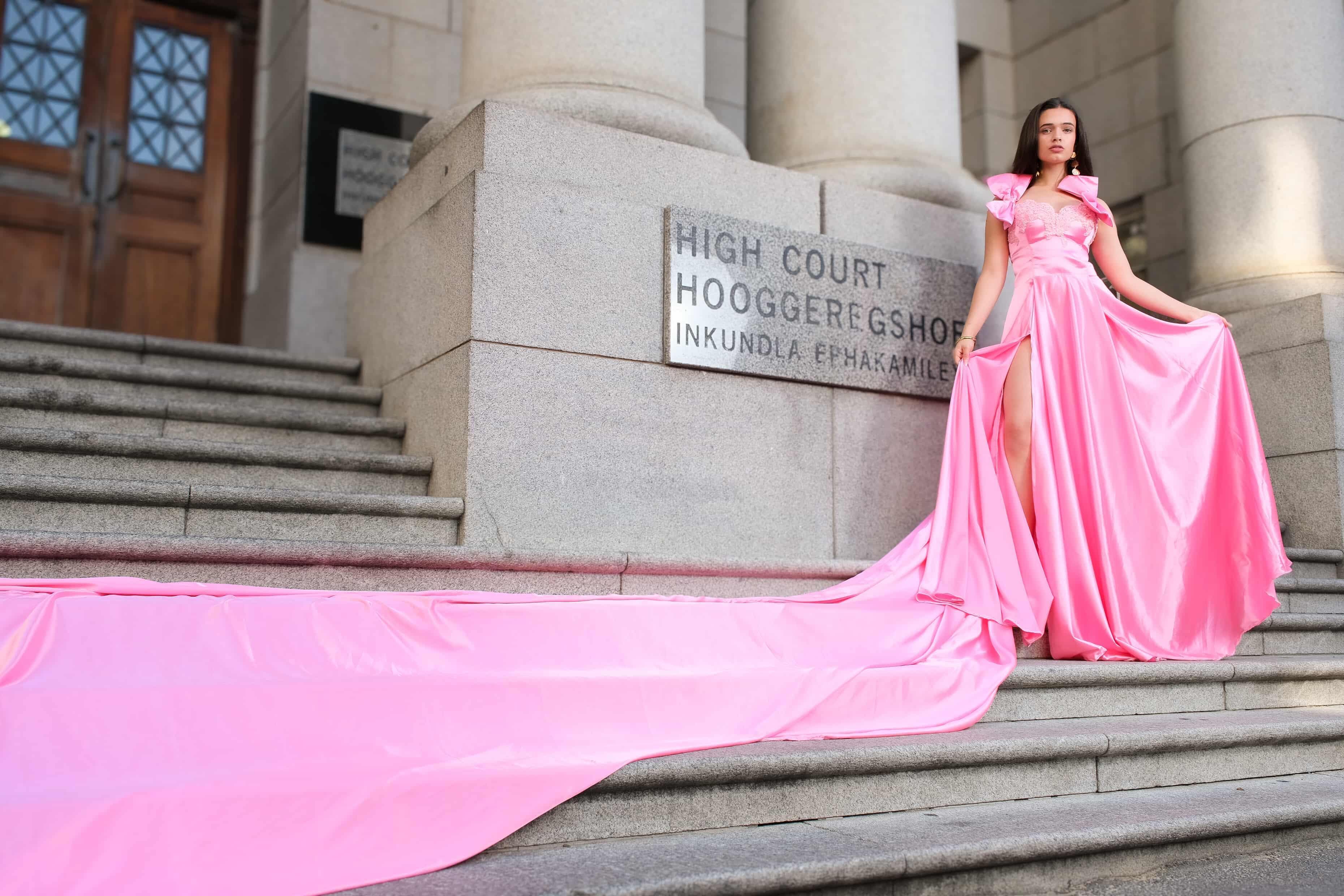 Woman in pink flying dress on stairs